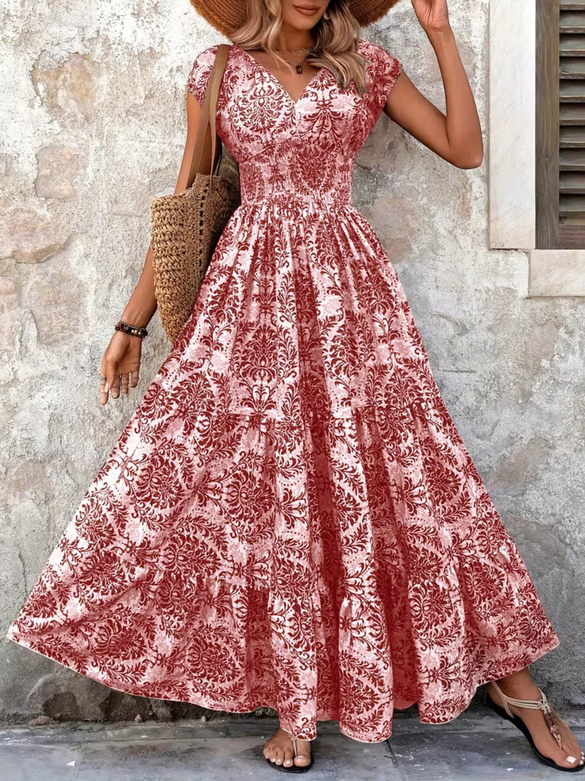 Green floral cap-sleeve maxi dress shown front-on with a smocked waist and full skirt.