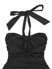 Close-up of ruched black halter neckline and tie detail
