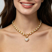 Pearl chain necklace with heart pendant worn with a smile