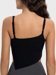 Peach workout cami shown in a turned side pose