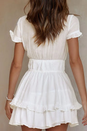 Back view showing smocked waist and tiered skirt