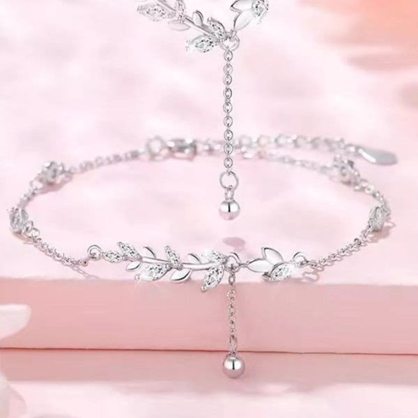 Close-up view of leafy silver bracelet links and dangling extension