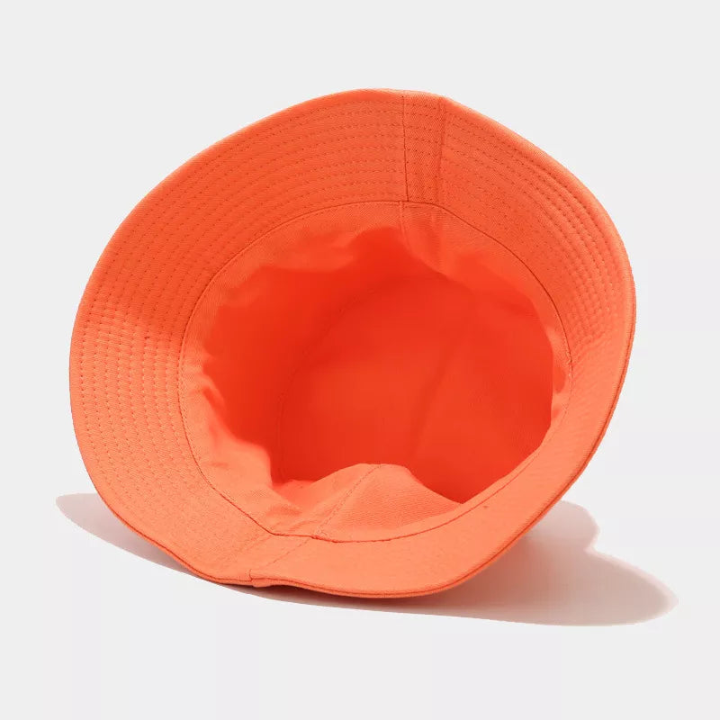 Orange bucket hat shown from the inside, revealing the crown and brim stitching