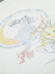 Close-up of illustrated circular graphic and lettering on white T-shirt