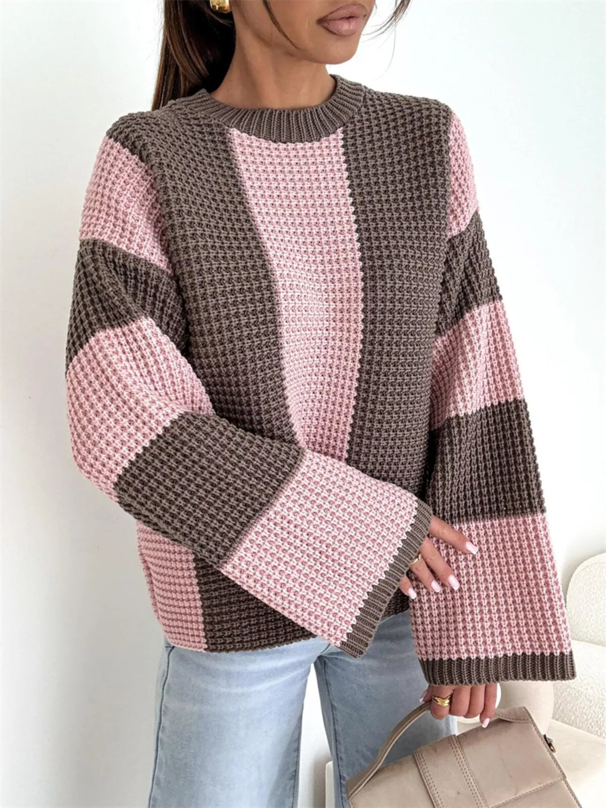 Front view of pink and brown sweater with wide vertical panels and flared sleeves
