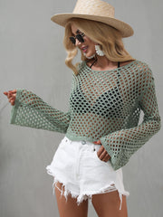 Model shows the wide bell sleeve of a sage green open-knit cropped cover-up.