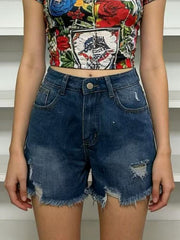 Dark blue distressed denim shorts shown from the front with a floral crop top