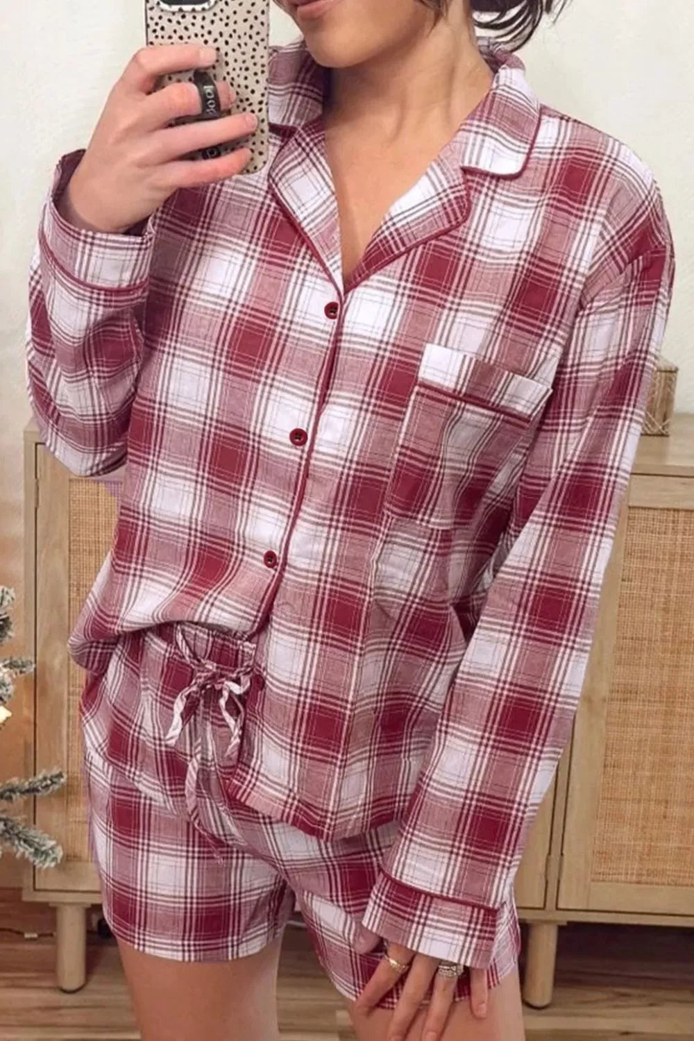 Model wearing red plaid button-front pajama shirt and shorts