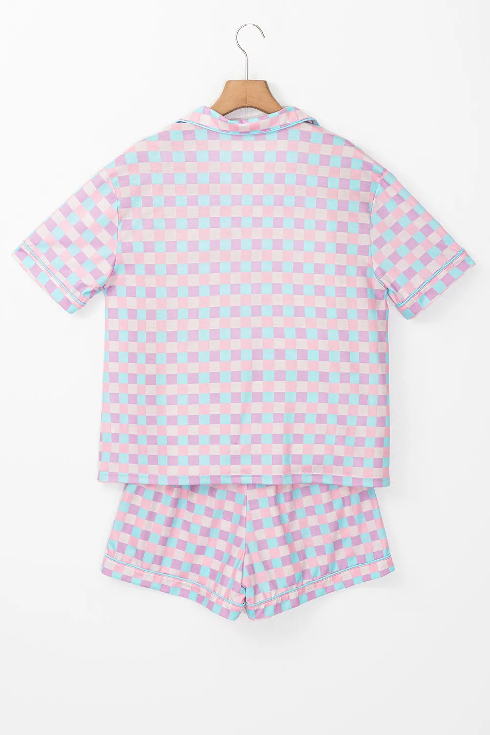 Pink and blue checked collared lounge shirt and matching shorts displayed on a hanger