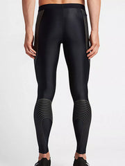 Back view of black active leggings with curved gray calf detailing
