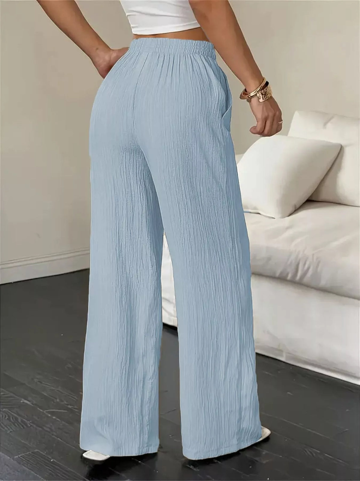 Back view of light-blue wide-leg pants with wide flowing legs