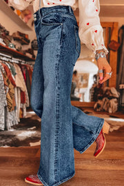 Angled view of blue wide-leg flare jeans and distressed wash