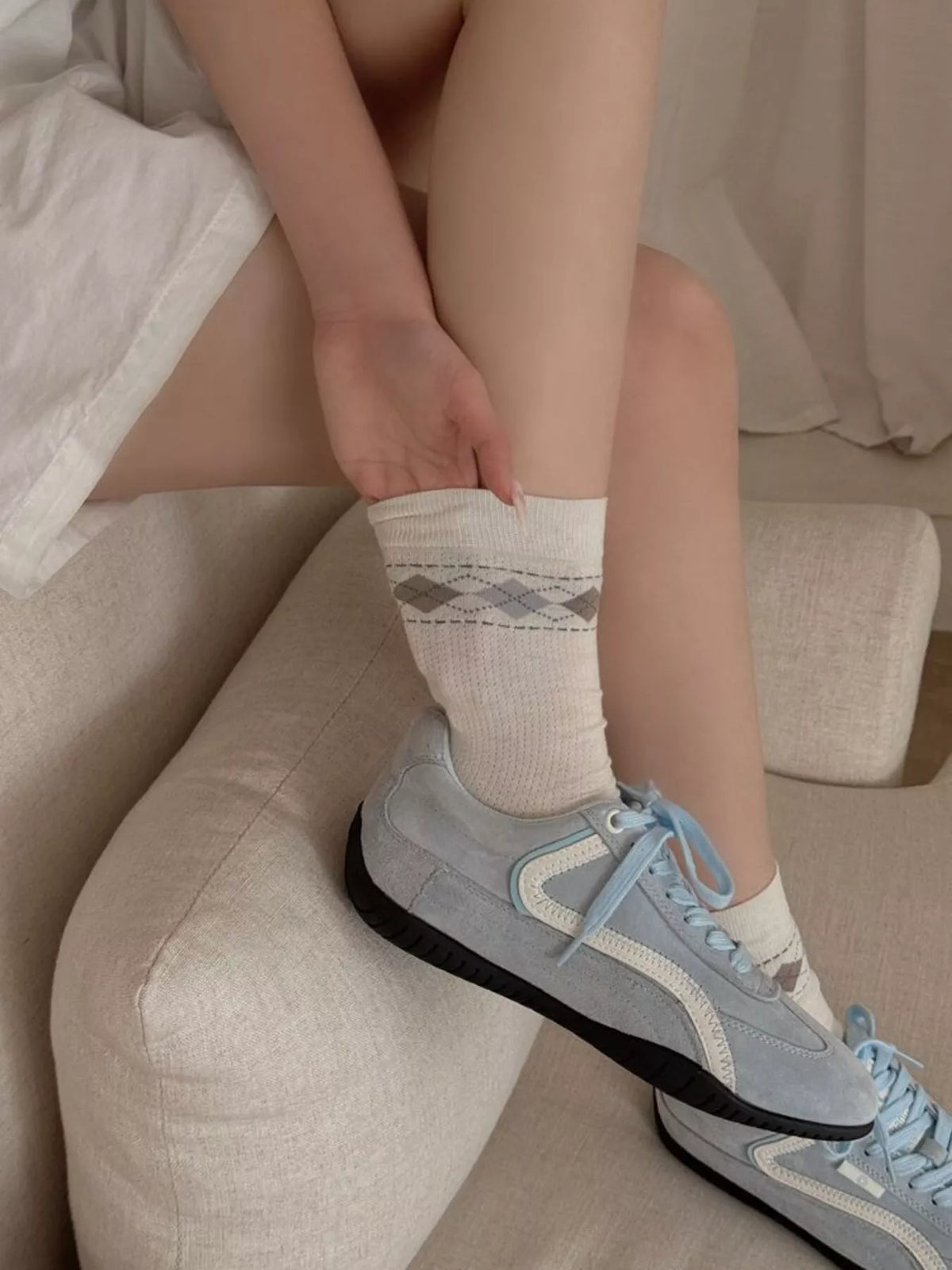 Cream argyle mid-calf socks styled with casual outfit and sneakers