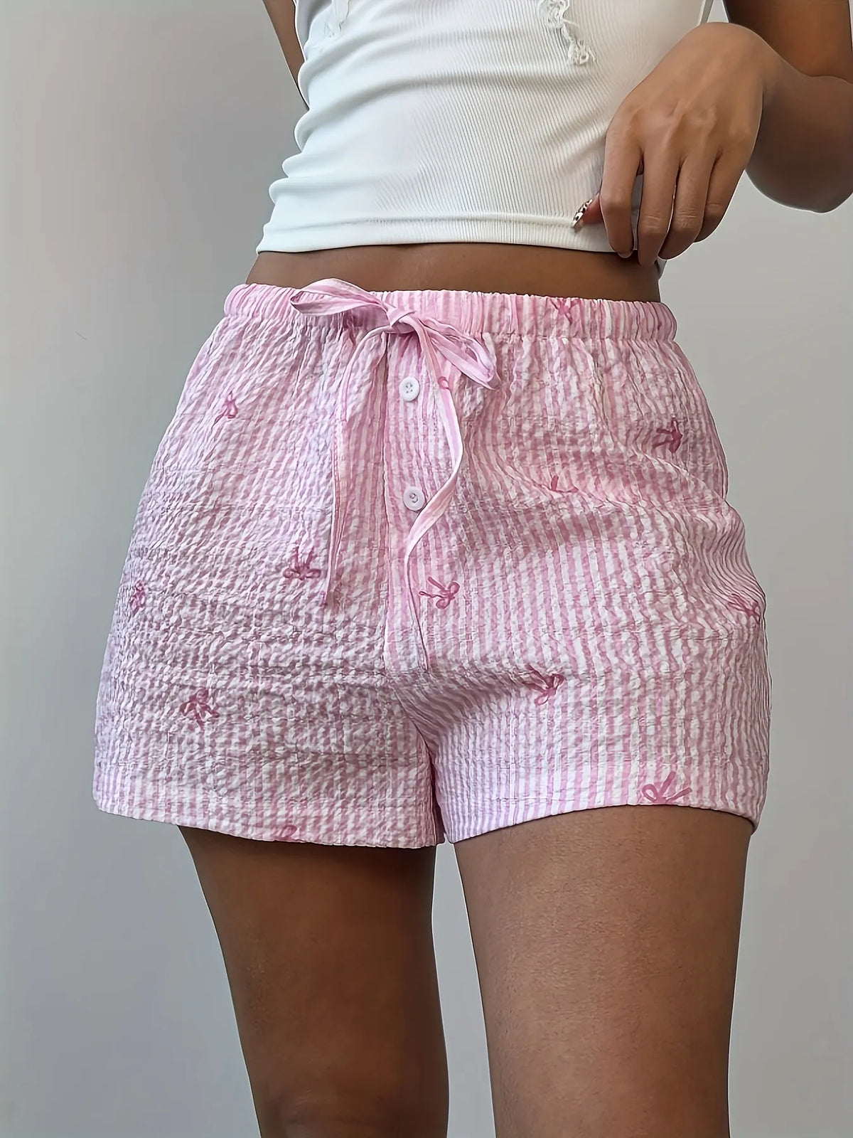 Close-up of pink plaid shorts and gathered drawstring waist
