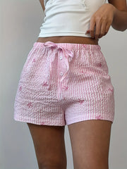 Close-up of pink plaid shorts and gathered drawstring waist
