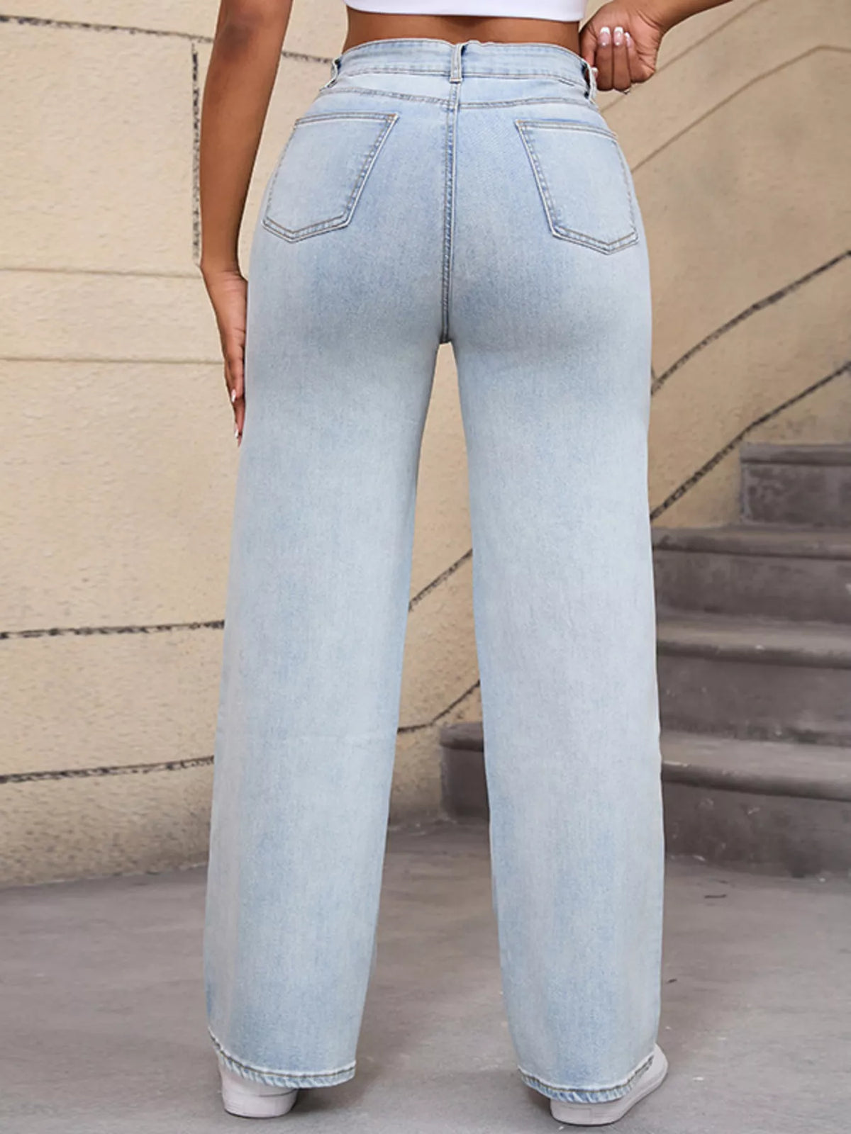 Straight rear view of light-wash wide-leg jeans with two patch pockets
