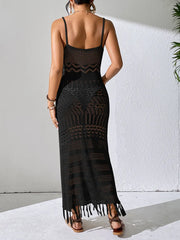 Back view of a black openwork cover-up dress showing thin straps and a fringed hem