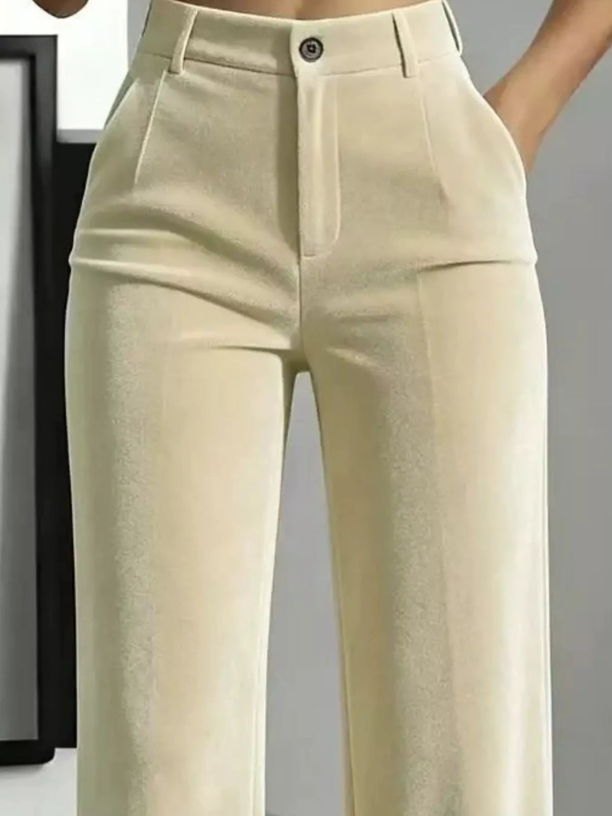 Close front detail of cream velvet pants showing button waist, belt loops and pockets