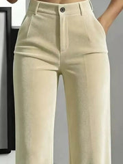 Close front detail of cream velvet pants showing button waist, belt loops and pockets