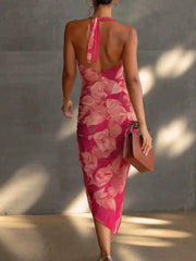Back view of the pink floral halter midi dress with neck ties and an open back.