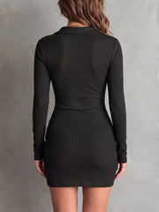 Close view of black dress buttons and gathered fabric along the front placket.