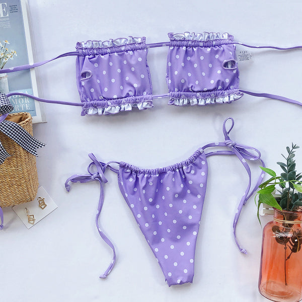 Lavender polka-dot bikini laid flat with the inside of the frill-trim top visible