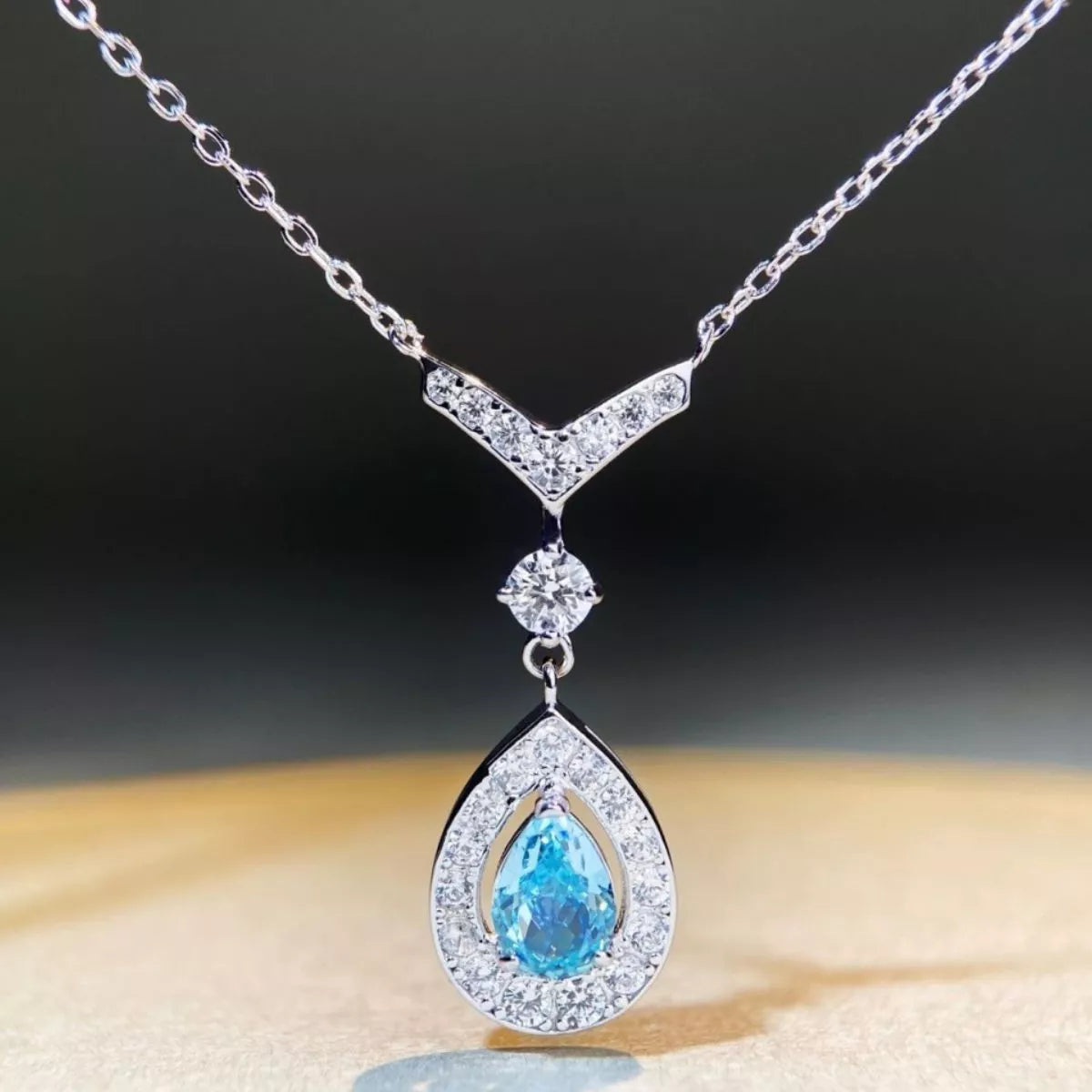 Teardrop pendant necklace in pastel blue displayed on a bust
