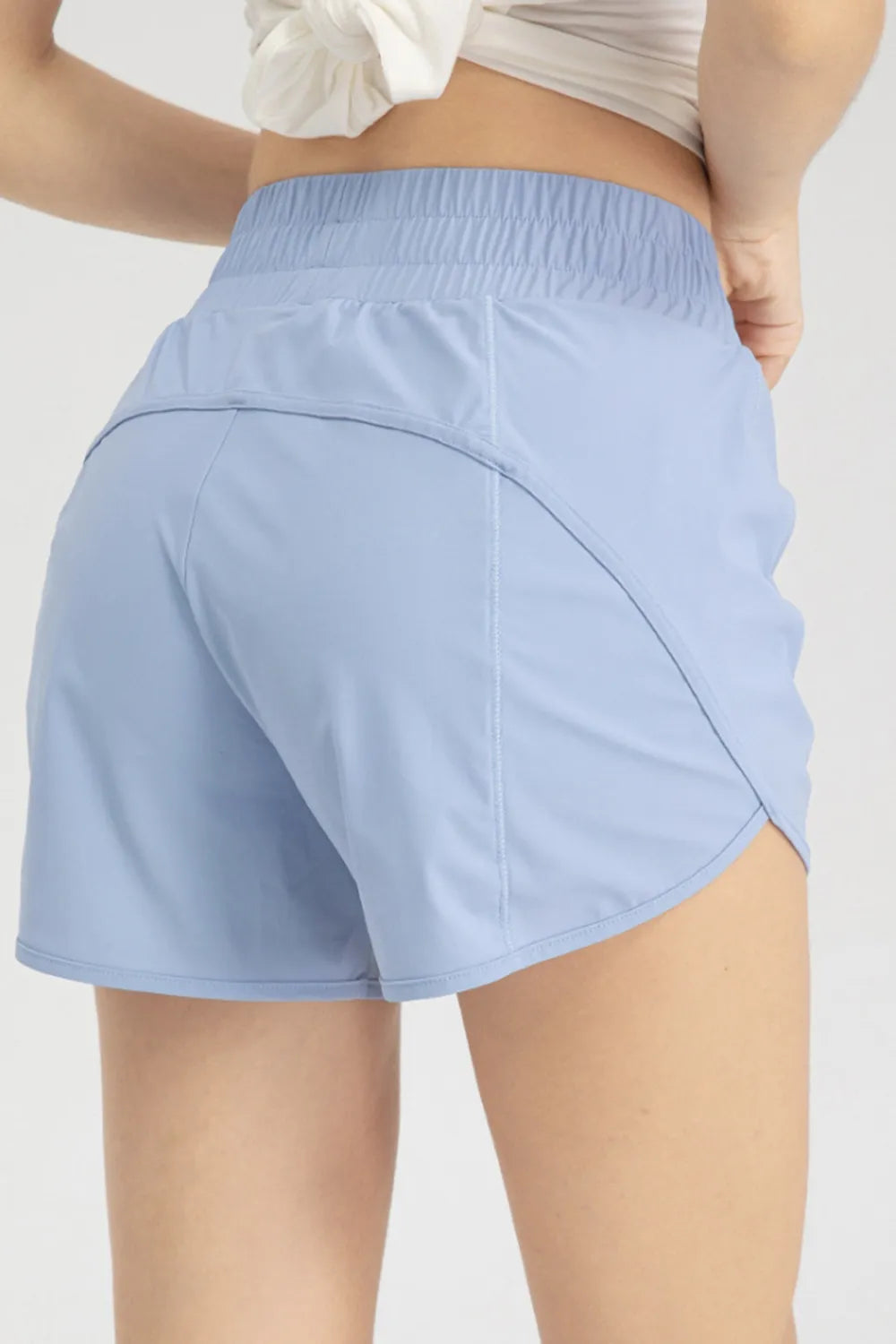 Back view of light blue active shorts showing curved rear seam