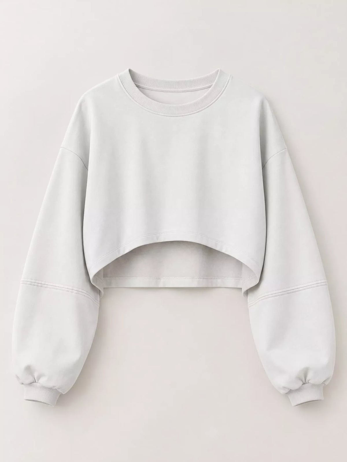 Light gray cropped sweatshirt shown flat from the front with gathered sleeve cuffs