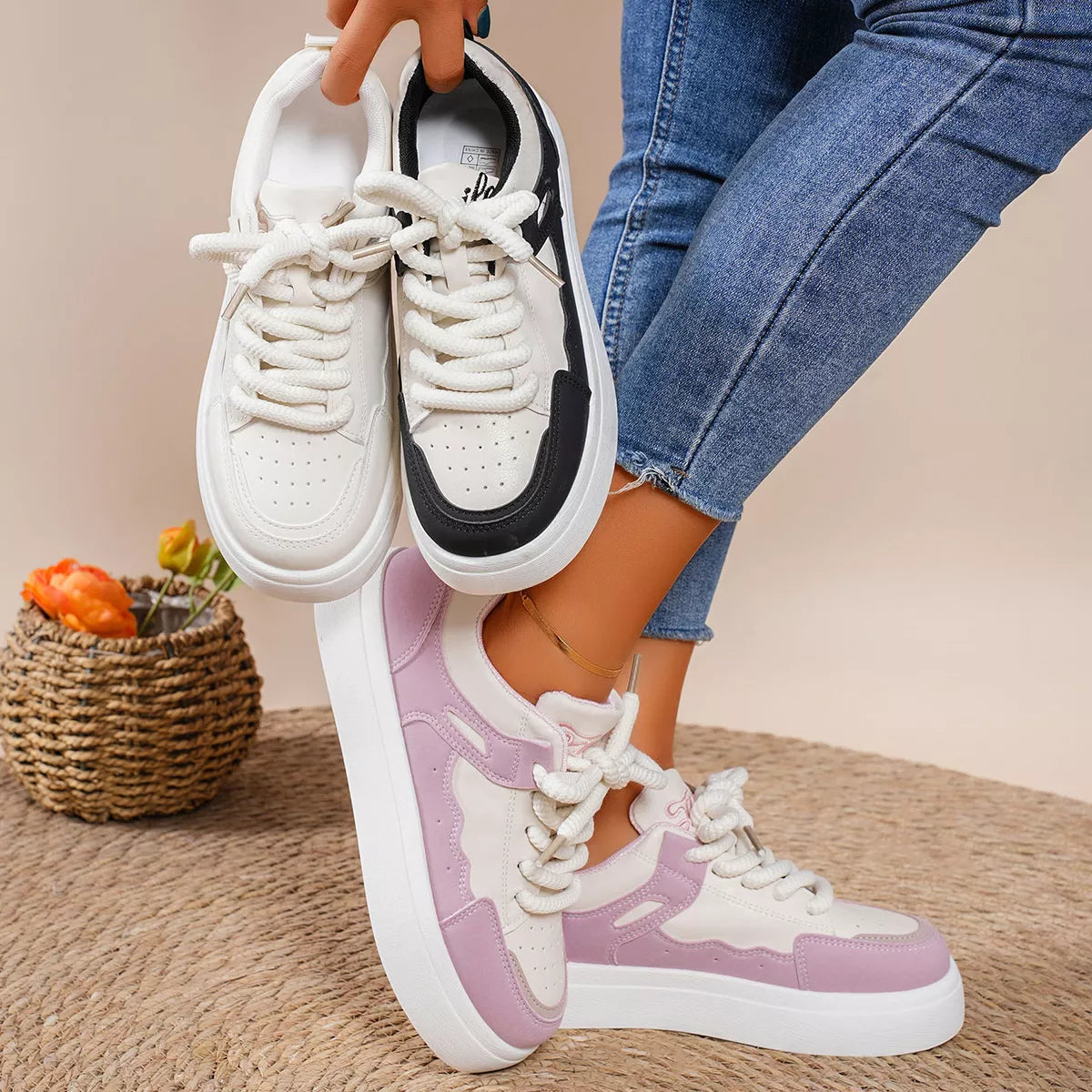 Pink and white platform lace-up sneakers shown with a black-and-white pair
