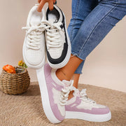 Pink and white platform lace-up sneakers shown with a black-and-white pair