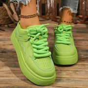 Front view of lime green platform sneakers with thick laces