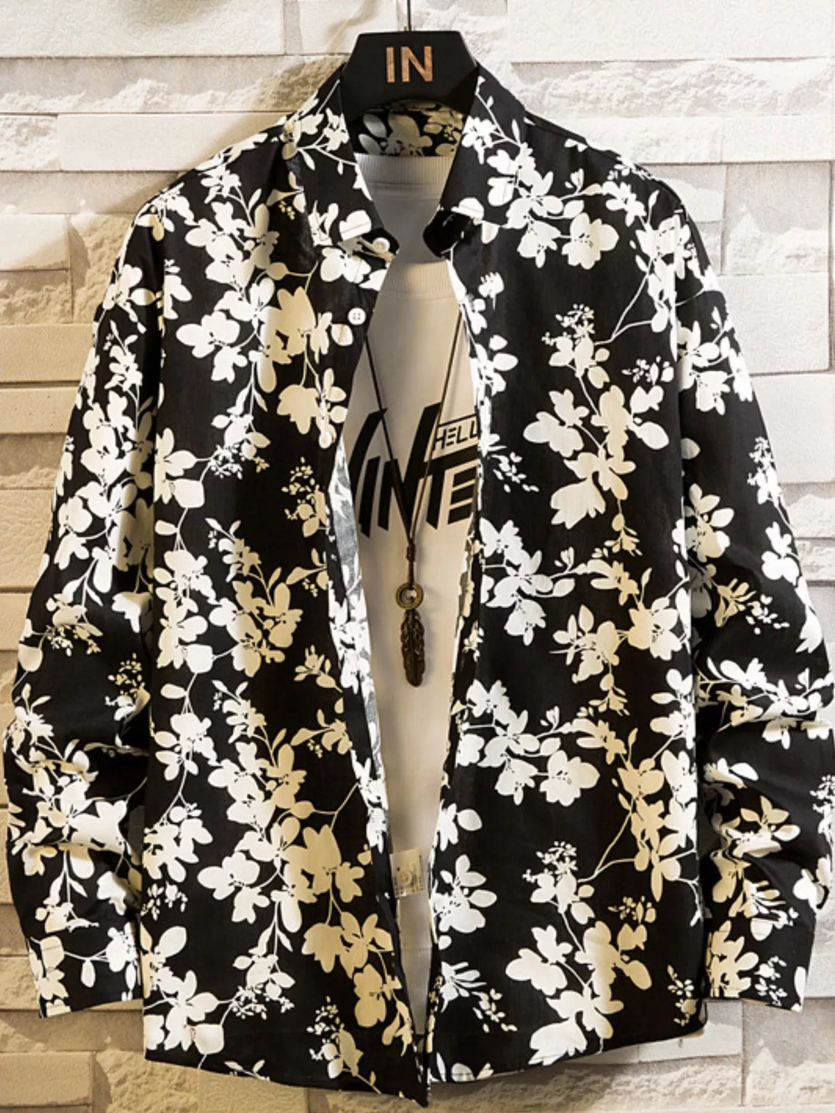 Black shirt with white floral print, front view