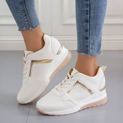 White wedge sneakers showing side profile and raised heel