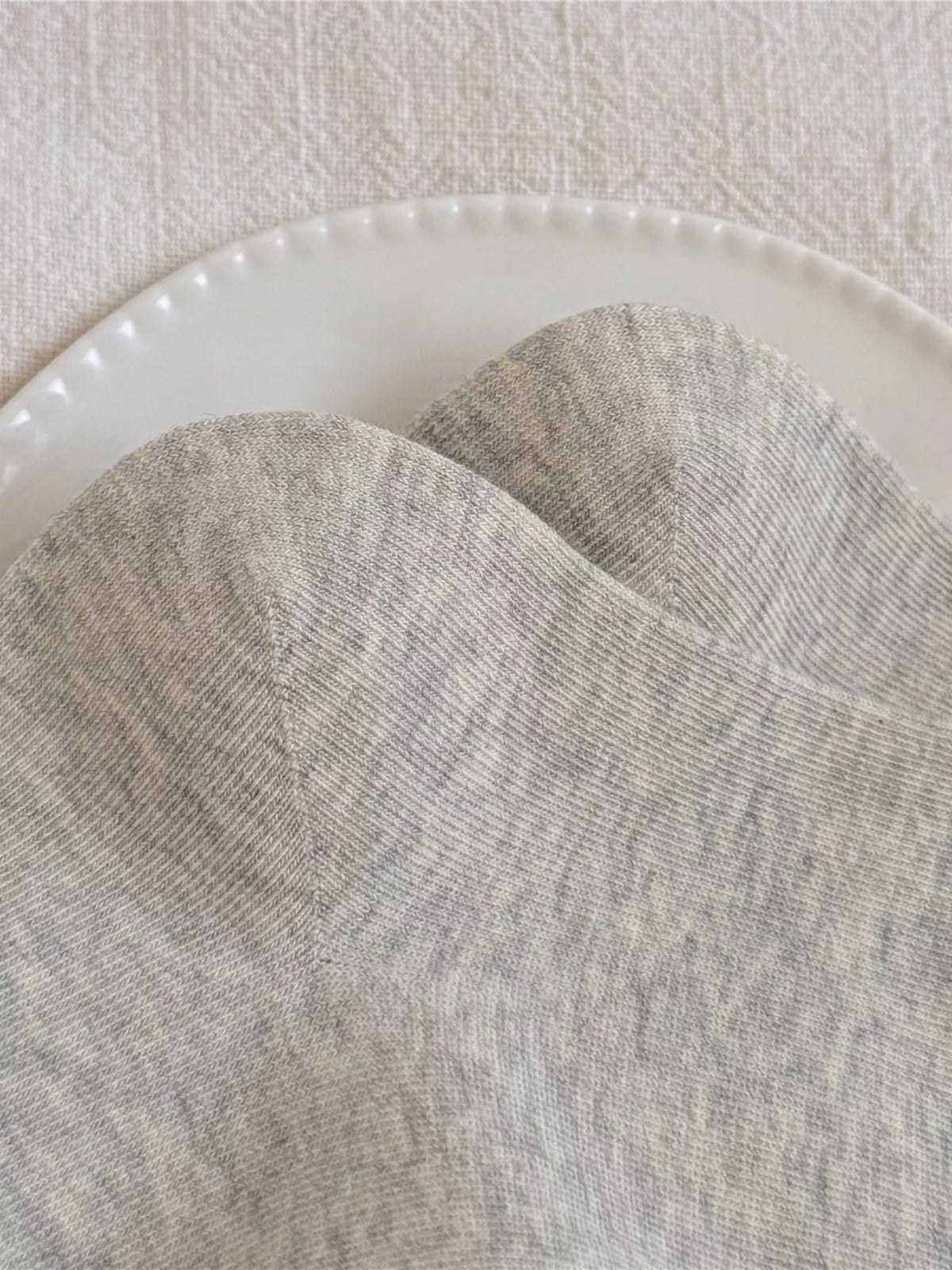 Gray socks showing the ribbed cuff and bear design
