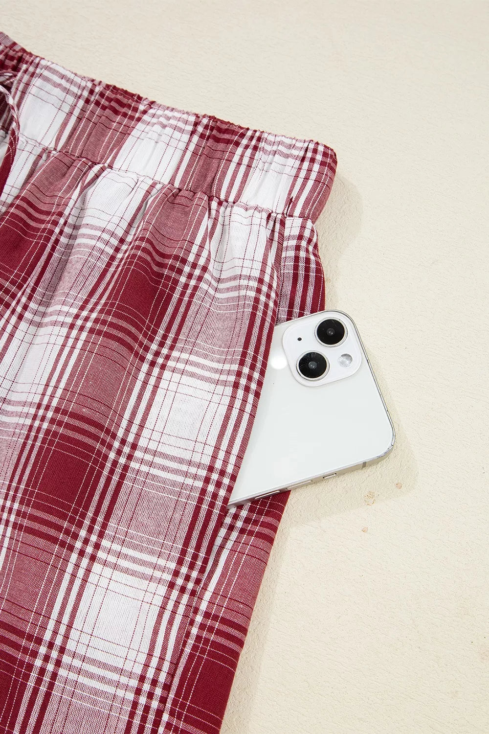 Close detail of plaid shorts elastic waistband and drawstring