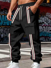Close view of the black joggers' cargo pockets and vertical stripes