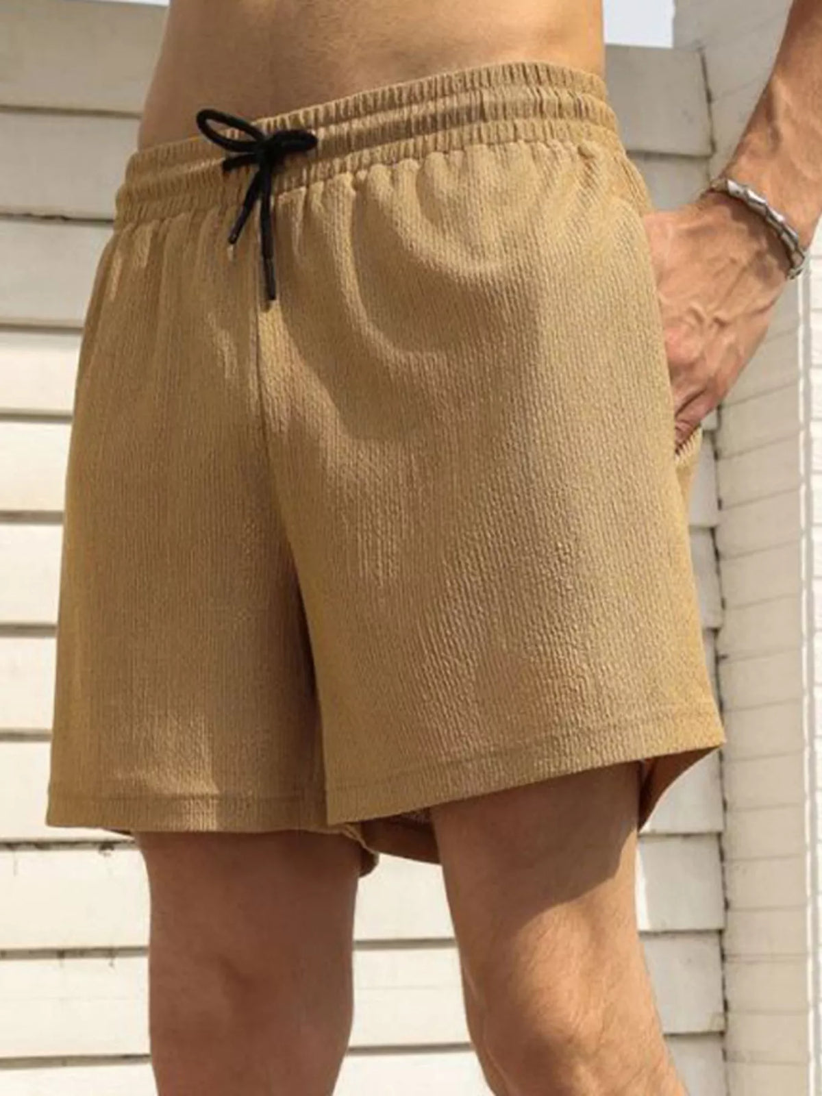 Model wearing tan drawstring shorts