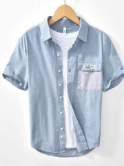 Light blue short-sleeve button-down shirt with chest pocket, front view
