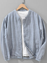 Blue-gray zip-up jacket layered over a white shirt