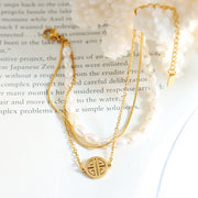 Three-layer pearl bracelet arranged on a printed page