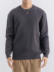 Charcoal grey ribbed sweater shown from the front with tan trousers