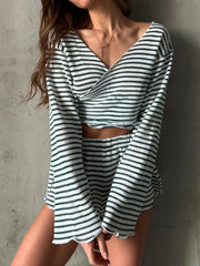 Model wearing a black-and-white striped wrap top and shorts set