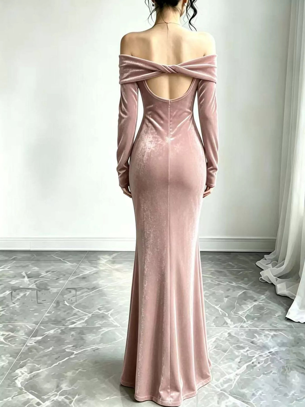 Blush pink velvet dress showing crossed back straps and long skirt