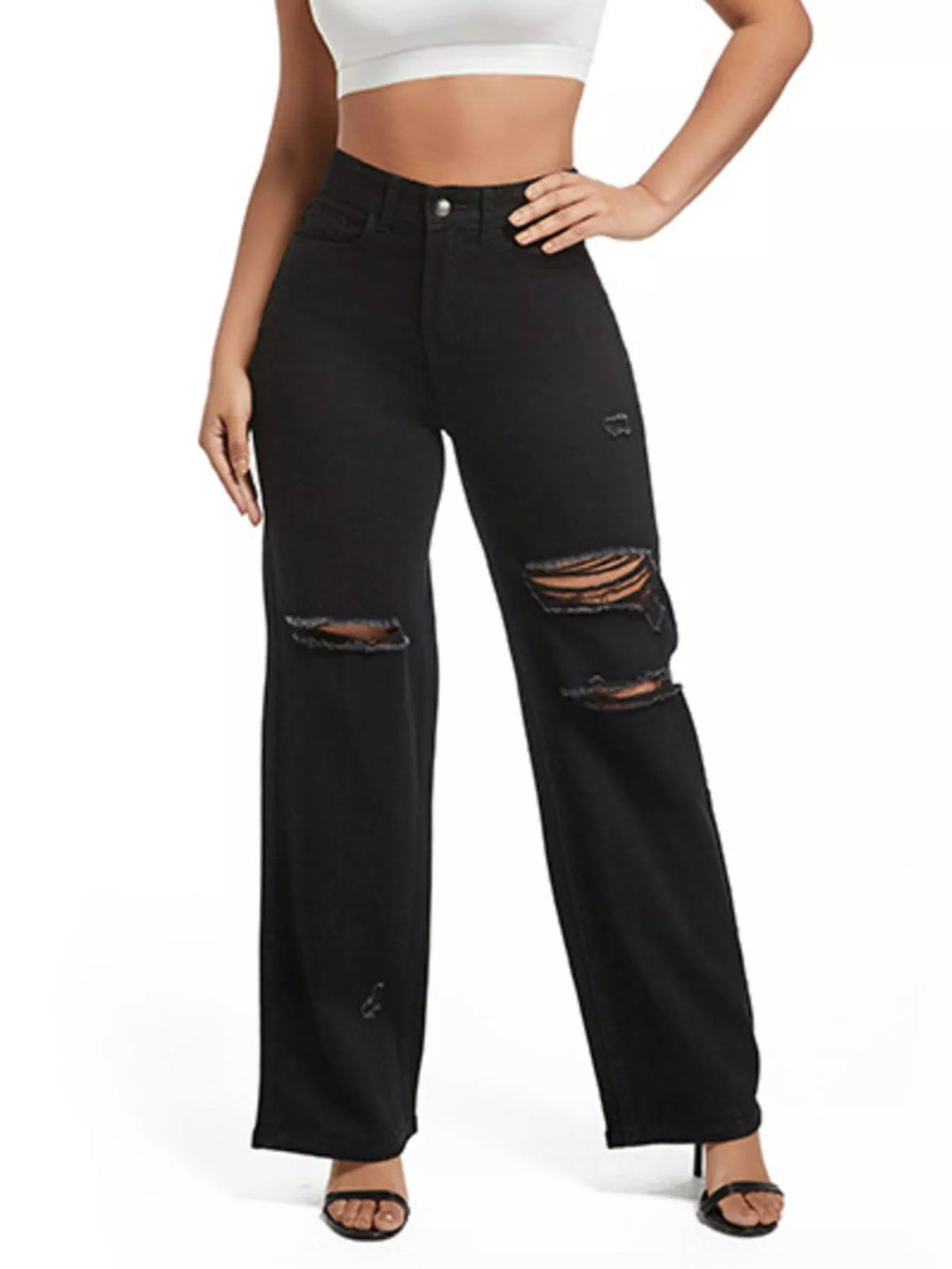 Black distressed wide-leg jeans styled with a white crop top and black open-toe heels
