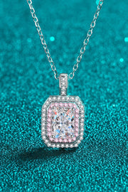 Rectangular clear-stone pendant with rounded corners and pink border on teal