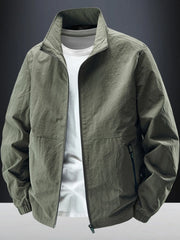 Dark olive stand-collar zip jacket displayed open over a white T-shirt