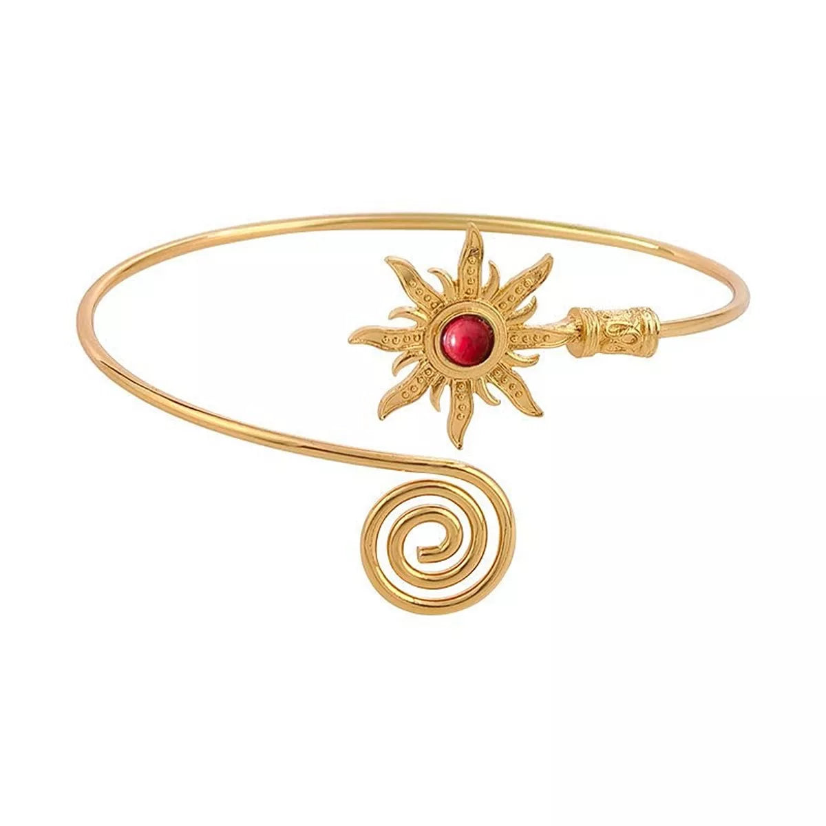 Gold-tone open cuff bracelet with red sunburst centerpiece on white background