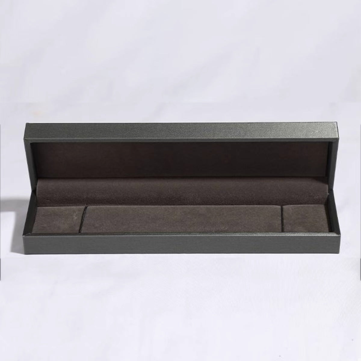 Open dark presentation box for the clover charm bracelet