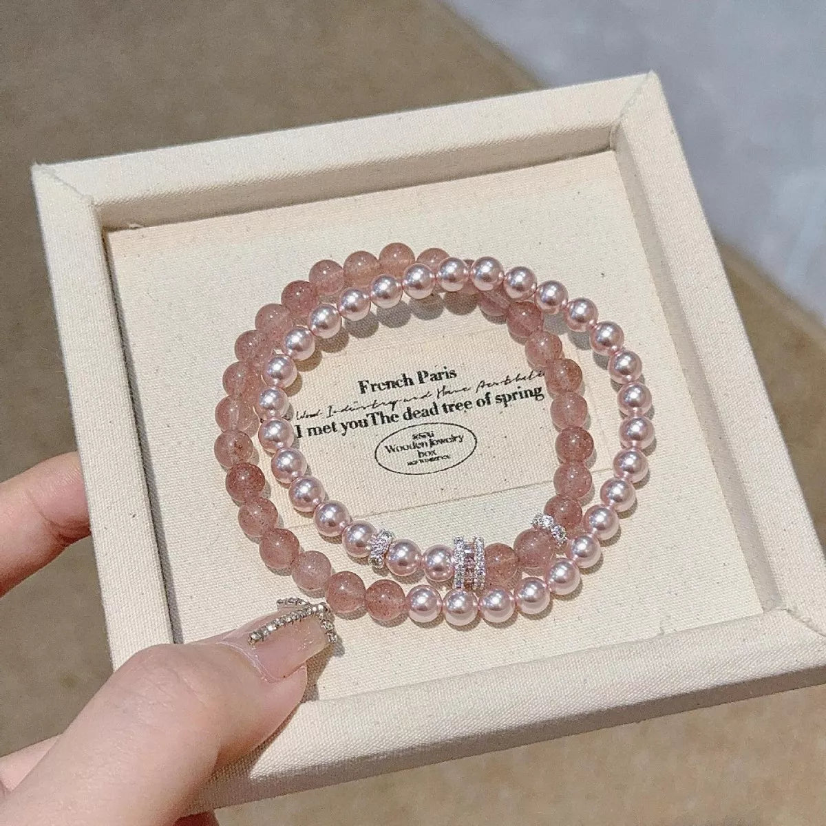 Two-piece dusty pink pearl bracelet set displayed in a box